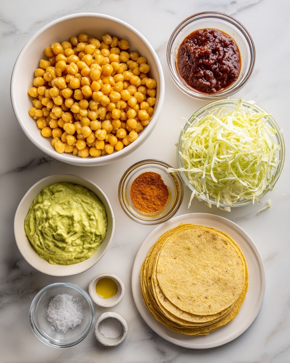 The image shows a top view of ingredients neatly arranged on a white marbled surface. At the top left, a white bowl is full of yellow chickpeas with a smooth texture. To the right of it, there are two small glass bowls, one with dark red tomato paste and the other with clear avocado oil. Below these, a white bowl contains thin, shredded pale green cabbage. In the center, a small glass bowl holds bright orange taco seasoning powder. Near the bottom left, there is a small glass bowl with creamy green avocado crema. Below it, a stack of yellow corn tortillas rests on a white plate, showing a slightly rough texture on top. Towards the bottom right, two tiny white bowls contain fine white salt and amber apple cider vinegar. All items are neatly separated and clearly visible. Photo taken with an iphone --ar 4:5 --v 7