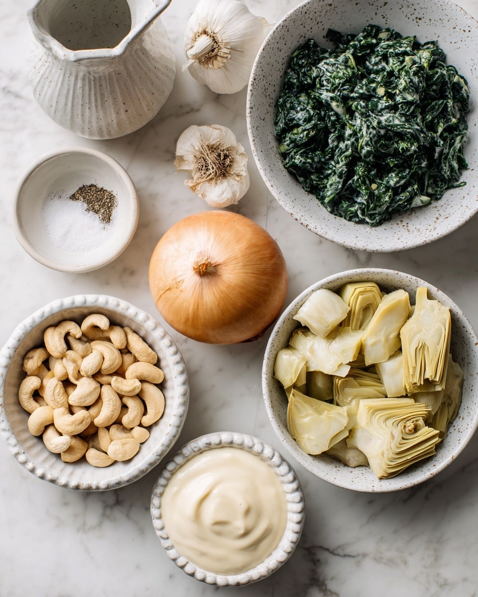 The image shows several ingredients arranged on a white marbled surface. In the center right, there is a white speckled bowl filled with dark green chopped frozen spinach. Below it to the right, a white bowl holds pale yellow artichoke hearts, cut into pieces. Next to it on the bottom right, another white bowl is filled with smooth, creamy off-white mayonnaise. To the bottom left, a white ribbed bowl contains light beige cashews. Above the cashews, a whole round light brown onion sits on the marble surface, and near it to the left is a garlic bulb with white papery skin. Above the garlic, a small white pitcher holds water. In the top left corner, a small white speckled bowl is filled half with coarse salt and the other half with ground black pepper. Photo taken with an iphone --ar 4:5 --v 7