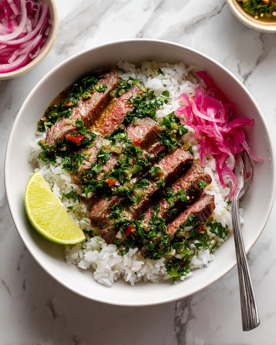 A white bowl holds a layered dish starting with a base of white rice, topped with several slices of medium-cooked steak showing a pink center and brown edges. The steak is covered with a fresh green herb mix with small bits of red chili and white onion. On one side of the bowl, there is a small pile of bright pink pickled onions, and on the other side is a wedge of lime with a light yellow-green color. A silver fork rests at the edge of the bowl. The bowl sits on a surface with a white marbled texture, and there are small bowls nearby filled with pickled onions and lime wedges. Photo taken with an iphone --ar 4:5 --v 7