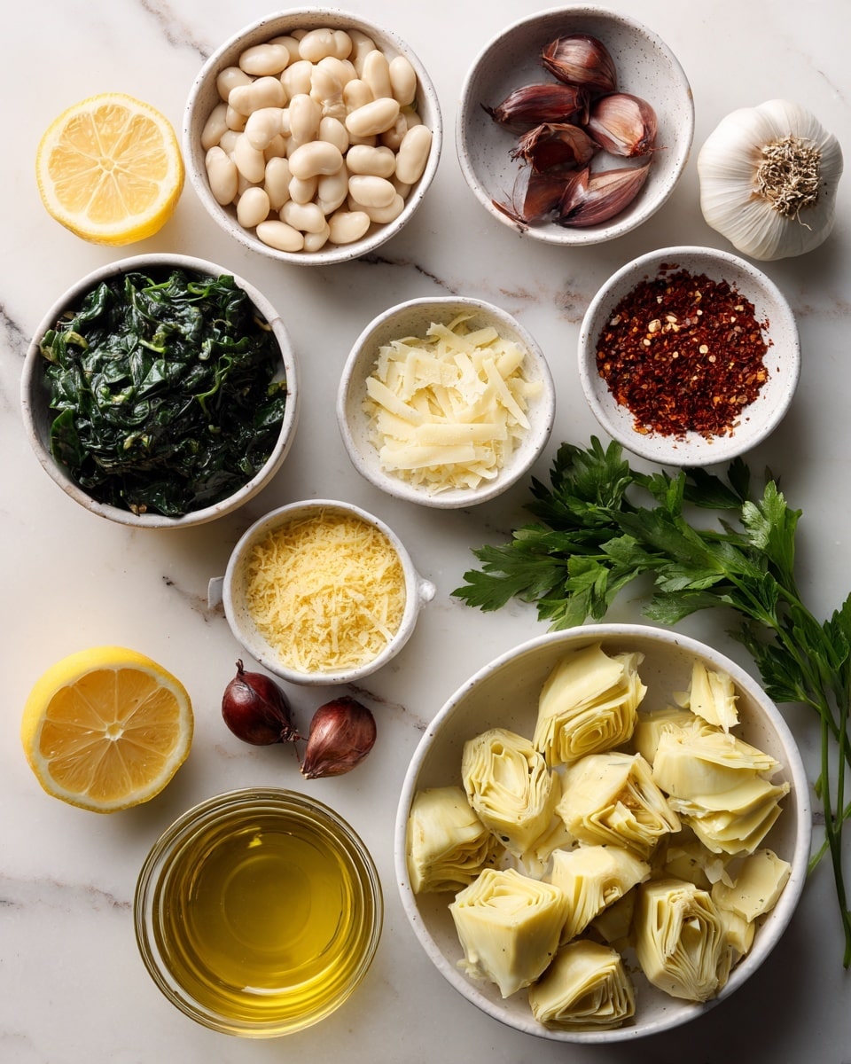 The image shows a clean white marbled surface with several white bowls and small glass containers arranged neatly. In the largest white bowl at the bottom right, pale yellow quartered artichoke hearts fill the space with a slightly soft texture. Next to it on the left is a smaller white bowl filled with dark green frozen spinach, finely chopped. Above that is another white bowl with light golden cashews, smooth and curved. To the left at the top, a bigger white bowl holds pale beige white beans, smooth and oval. Near the center, a small white bowl contains yellow nutritional yeast flakes, fine and powdery. Beside it, a cluster of red pepper flakes adds a bright red touch in a tiny white bowl. Two brown shallots with smooth skins lie directly on the surface near the top center. A small bowl of shredded pale yellow dairy-free parmesan is just right of the shallots. To the right is a handful of fresh green parsley with textured leaves. Below the parsley, a clear glass bowl holds golden olive oil, shiny and thick. A bright yellow lemon half with a juicy texture sits on the left near a small cluster of white garlic cloves with smooth skins. Another clear glass bowl shows amber vegetable broth, and a small glass container holds clear water, both near the bottom left. The overall layout is clean, organized, and clearly shows each ingredient with soft natural lighting. photo taken with an iphone --ar 4:5 --v 7