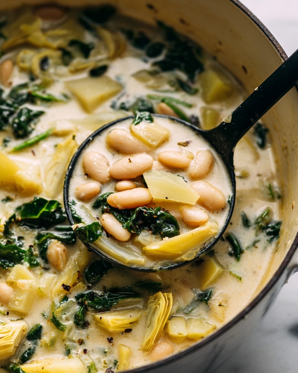 A close-up view of a creamy soup filled with small white beans, pieces of pale yellow artichoke, and dark green chopped leafy vegetables mixed evenly in a thick white broth. A black ladle scoops some of the soup, showing the soft texture of the beans and vegetables. The pot holding the soup is visible at the edges with a thin dark rim, and the background is a white marbled texture. photo taken with an iphone --ar 4:5 --v 7