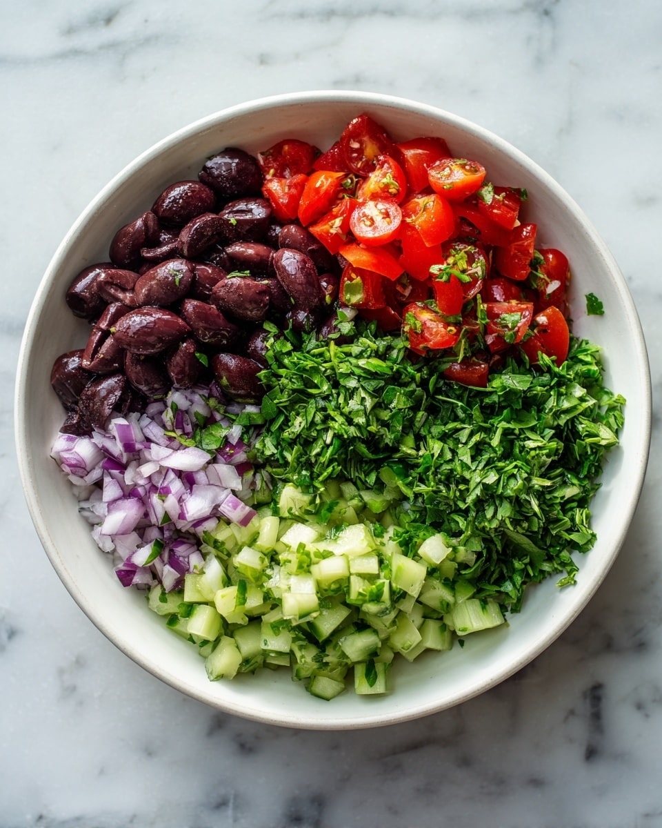 A white bowl sits on a white marbled surface filled with five distinct piles of chopped ingredients arranged in a circle without mixing: dark purple chopped olives at the top, bright green chopped herbs on the right, red chopped tomatoes at the bottom right, pale green chopped cucumber at the bottom left, and finely chopped light purple onion pieces in the center. The textures vary from smooth olives to leafy herbs and juicy tomatoes. photo taken with an iphone --ar 4:5 --v 7