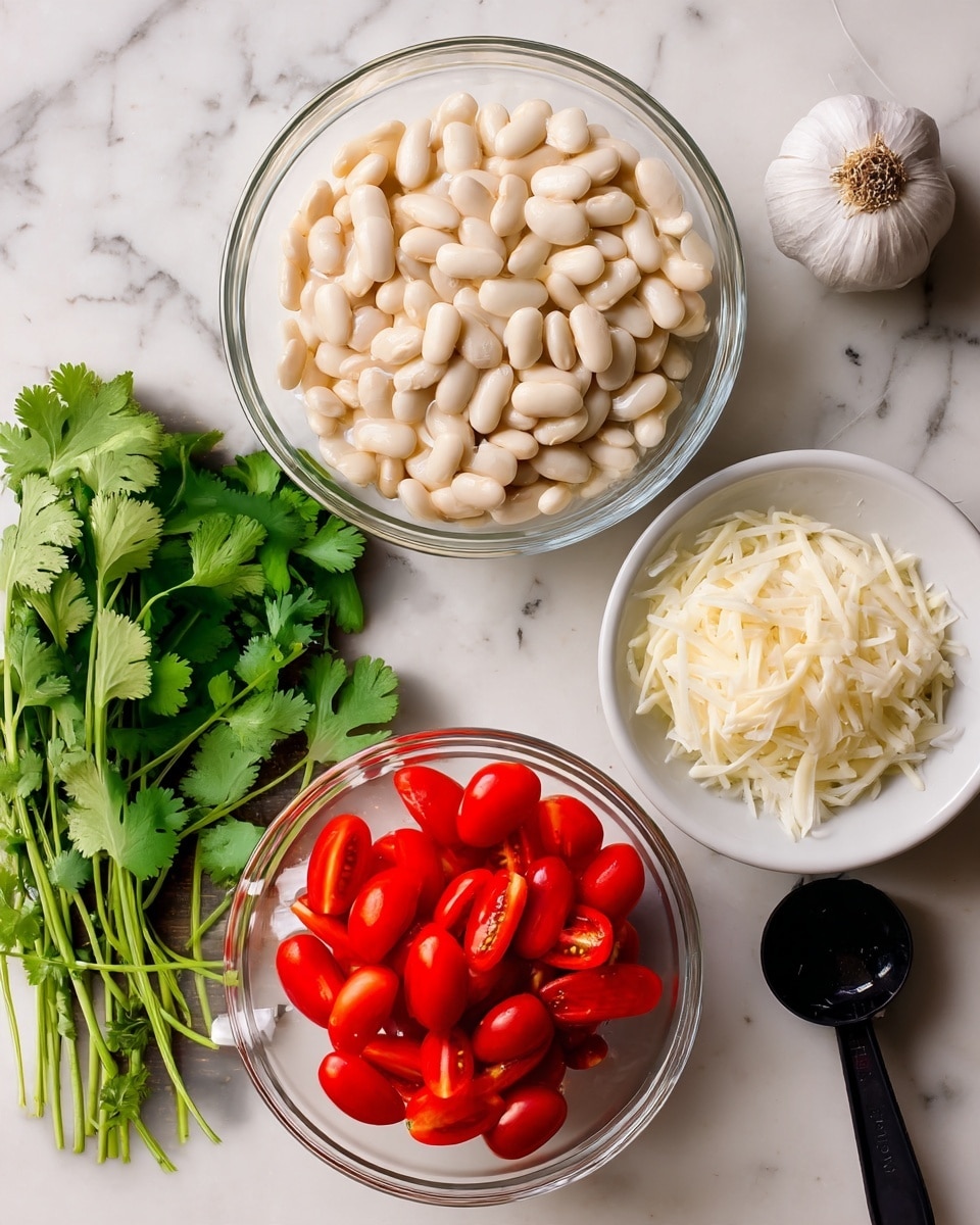 The image shows a top view of ingredients on a white marbled surface. There is a large clear glass bowl filled with small white beans placed near the center. Below it, a smaller clear glass bowl contains halved red cherry tomatoes. To the right of the beans, a white bowl holds white shredded or shaved cheese pieces. Below this bowl, a black measuring spoon is filled with finely chopped white onions. On the left side, a bunch of fresh green cilantro leaves rest next to a bulb of garlic with some cloves visible. The scene captures natural colors and textures with a rustic feel. photo taken with an iphone --ar 4:5 --v 7
